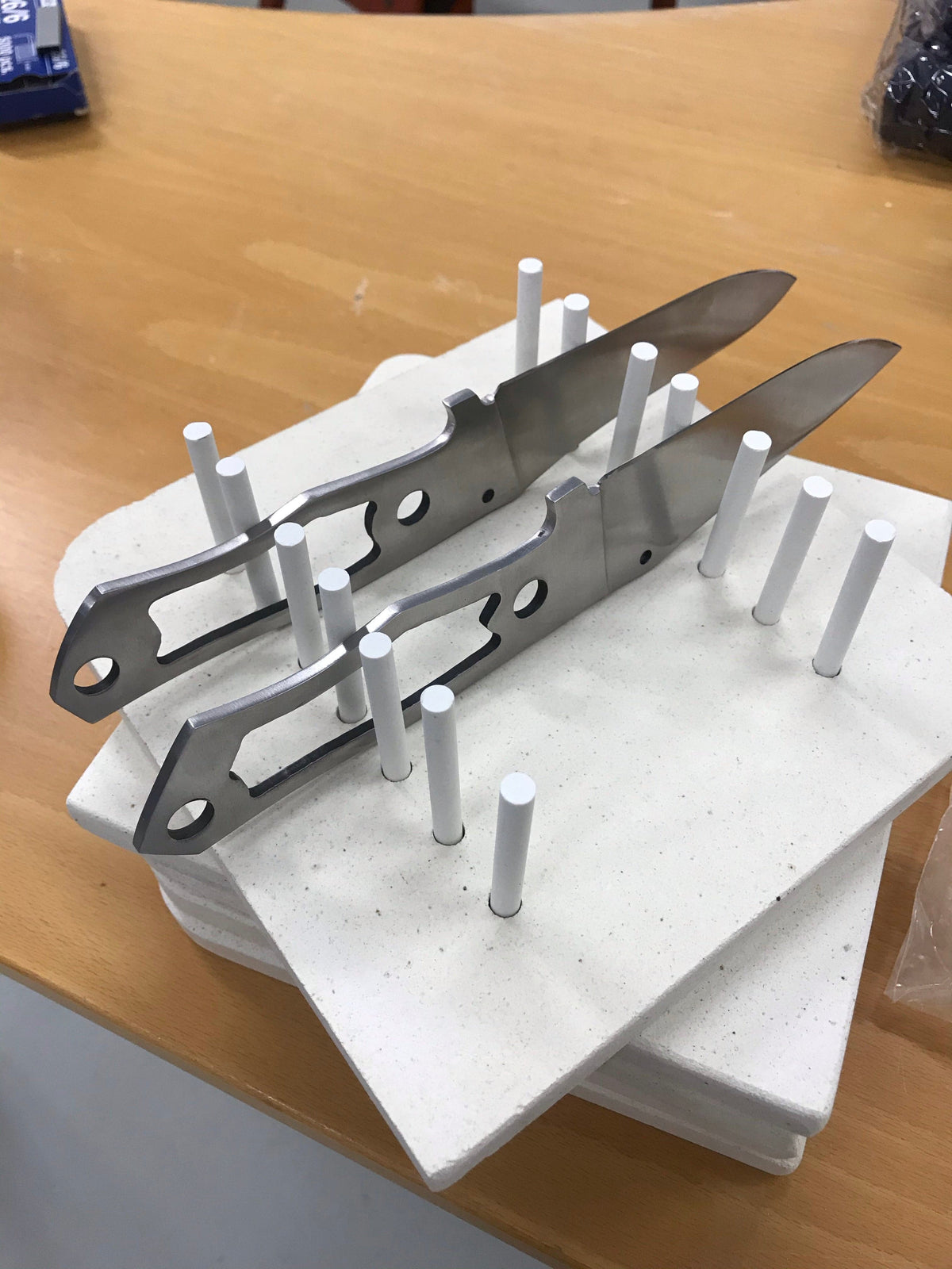 Knife blade holder for curing oven